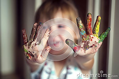 Education, school, art and painitng concept - little girl showing painted hands Stock Photo