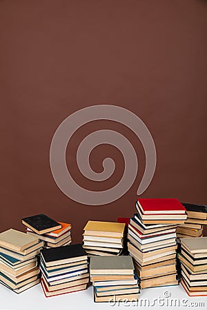 education science learning library stack of books on brown background Stock Photo