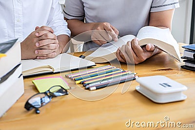 Education, teaching, learning concept. High school students or classmates group tutor in library studying and reading with helps Stock Photo