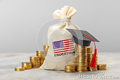 Education in the USA. Concept for expensive education in America. Day bag with a furnace of gold coins with a graduate Stock Photo