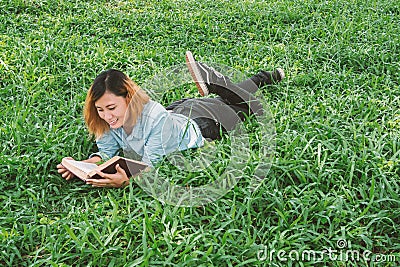 Education woman.Young beautiful woman reading a book in the park Stock Photo