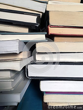 Educational books piled on table Stock Photo