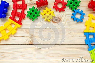 Educational building kit on wooden table. Multicolored toys for kindergarten, preschool or daycare. Copy space for text. Top view. Stock Photo