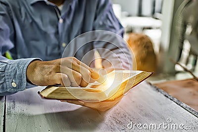 Educational concept. Old book in man& x27;s hands Stock Photo