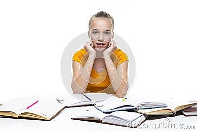 Educational Ideas. Portrait of Exhausted Caucasian Teenager Girl Posing with Lots of Books. Isolated On White Stock Photo