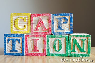 Educational toy cubes with letters organised to display word CAPTION - editing metadata and Search engine optimisation Stock Photo