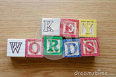 Educational toy cubes with letters organised to display word KEYWORDS - editing metadata and Search engine optimisation Stock Photo