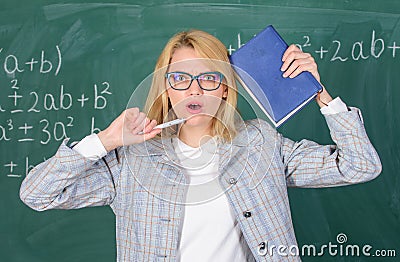 Educator woman hold book and pen chalkboard background. Inspired work harder or pursue particular goal. Learn be Stock Photo