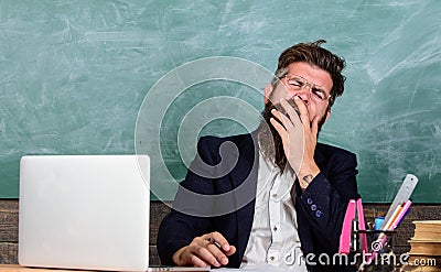 Educators more stressed at work than average people. High level fatigue. Educator bearded man yawning face tired at work Stock Photo