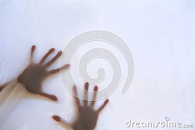 Eerie blurry hands of people as if they have been trapped behind glass, dense fabric, wrap, ghost, spirit trying to reach out from Stock Photo