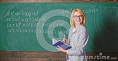 Effective teaching involve acquiring relevant knowledge. Woman teaching near chalkboard in classroom. Qualities that Stock Photo