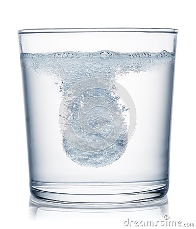 Effervescent tablet dissolving in a glass of water. Clipping path Stock Photo