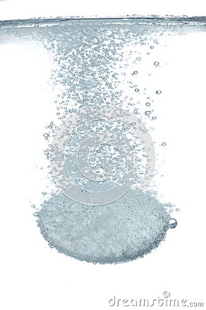 Effervescent tablet fallind in water Stock Photo