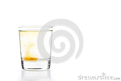 Effervescent vitamin C tablet bubbles in glass of water Stock Photo