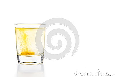 Effervescent vitamin C tablet bubbles in glass of water Stock Photo