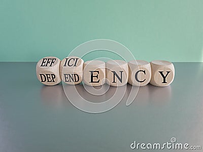 Efficiency or dependency symbol. Turned cubes, changes the word dependency to efficiency Stock Photo