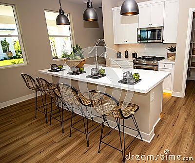 Efficient Kitchen With Island And Bar Stools Stock Photo