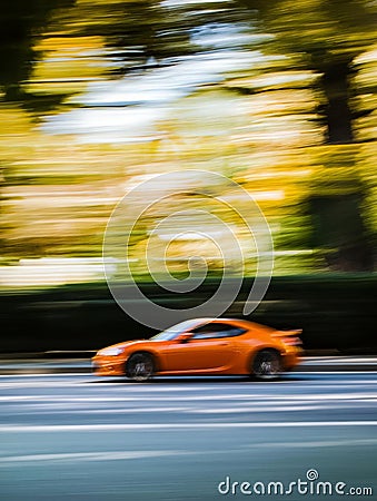 Effortlessly gliding through a twisting course, a dynamic sports vehicle commands attention. Stock Photo