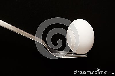 Egg Balanced on a Fork Stock Photo