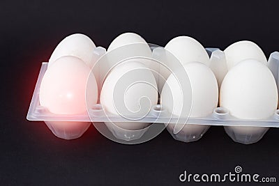 Egg on a black background that is infected with salmonella, close-up, contamination salmonella Stock Photo