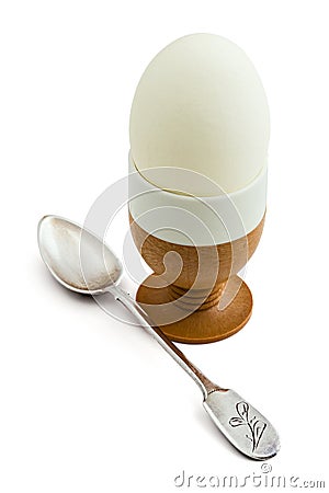 Egg in eggcup and teaspoon isolated Stock Photo