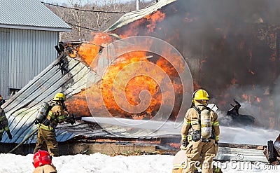 Egg farm fire.Firefighters battle blazing barn. Editorial Stock Photo