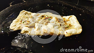 Egg frying on a big pan at a road side street shop Stock Photo