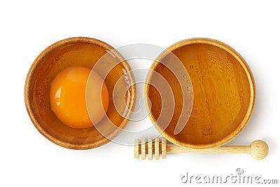 Egg and honey in wooden bowl on white background - Homemade beauty mask ingredients Stock Photo