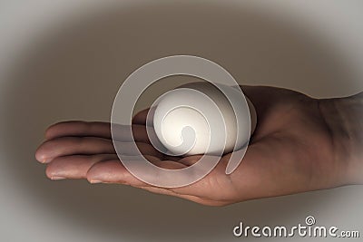 Egg laying on a womans hand Stock Photo