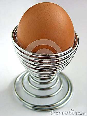 Egg in metal spiral eggcup Stock Photo