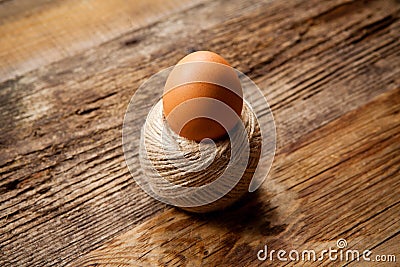 Egg in rope coil on old Stock Photo