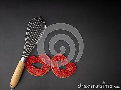 Egg whisk with Strawberry puff heart Stock Photo