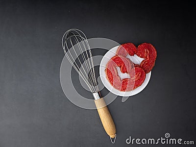 Egg whisk with Strawberry puff heart Stock Photo