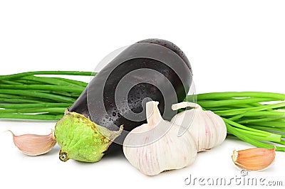 Eggplant in droplets of water, two heads of garlic and stalks of green onions, depicted on a white background Stock Photo