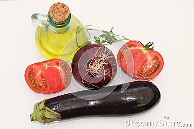 Eggplant, red onion, tomato and glass oil Stock Photo