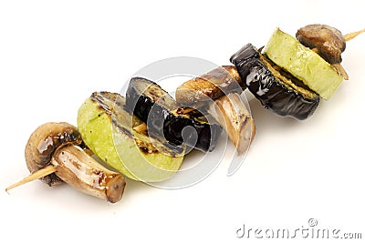 Eggplant, zucchini and mushrooms champignons grilled on a grill on a spit Stock Photo