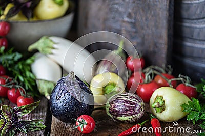 Eggplants of different colors and different grades on a wooden table Stock Photo