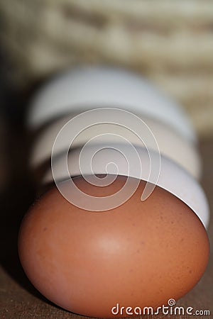 Eggs of different colors from the village hens lay to each other Stock Photo