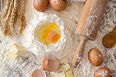 Eggs, dough, flour and rolling-pin baking cakes on wooden table Stock Photo