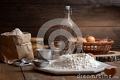 Eggs, dough and flour on wooden table with splat background Stock Photo