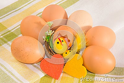 Eggs with easter decoration and felt hearts on cotton napkin. Stock Photo