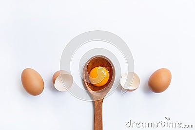 Eggs, egg yolk on wooden spoon isolated Stock Photo