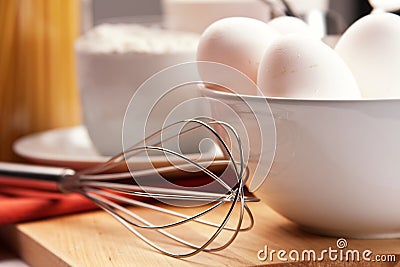 Eggs and eggbeater Stock Photo