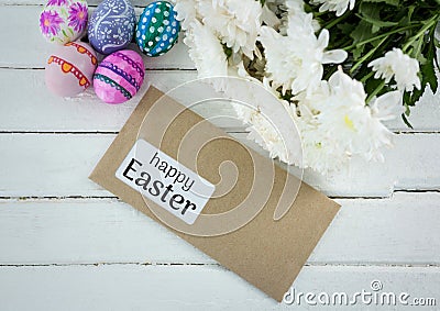 Eggs, flowers and envelope with grey type on table Stock Photo