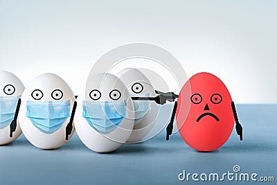 Eggs in medical masks condemn a red egg without a protective mask Stock Photo