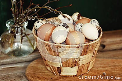 Eggs pottle glass vase branch wood table easter spring Stock Photo