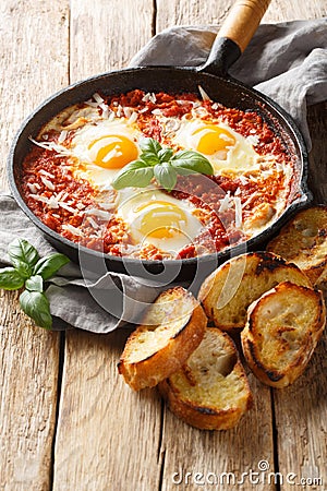 Eggs in Purgatory is an easy Italian dish served with lots of crusty bread for dipping closeup. Vertical Stock Photo