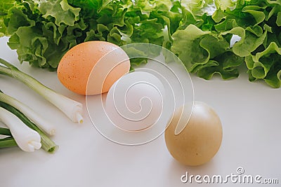 Eggs and salad and garlic leaf on the table Stock Photo
