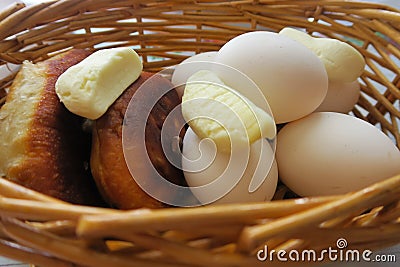 Eggs, sweets, frame nuts and pies in the basket. Stock Photo