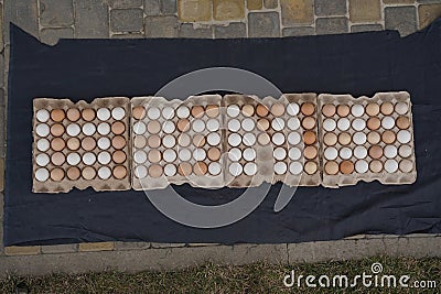 Eggs top view. Packing of fresh chicken eggs on marble background. Lots of packs. 128 pieces Stock Photo